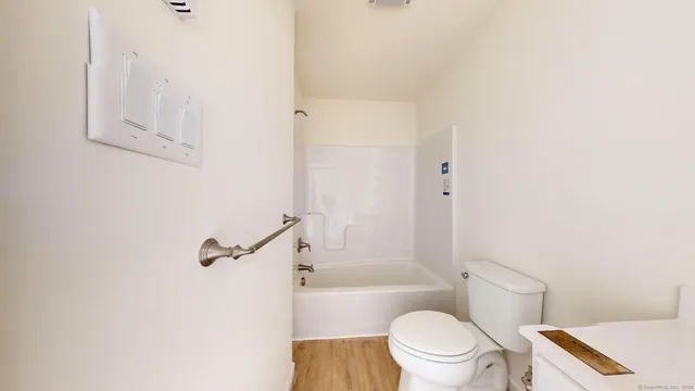 a white toilet sitting next to a bathroom sink