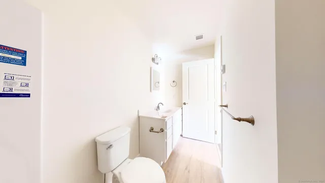 a white toilet sitting next to a bathroom sink