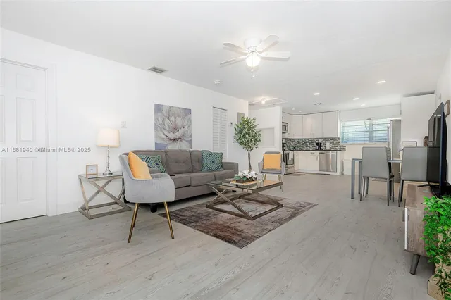 a living room with furniture and kitchen view