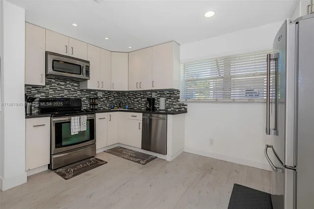 a kitchen with stainless steel appliances granite countertop a stove and a microwave