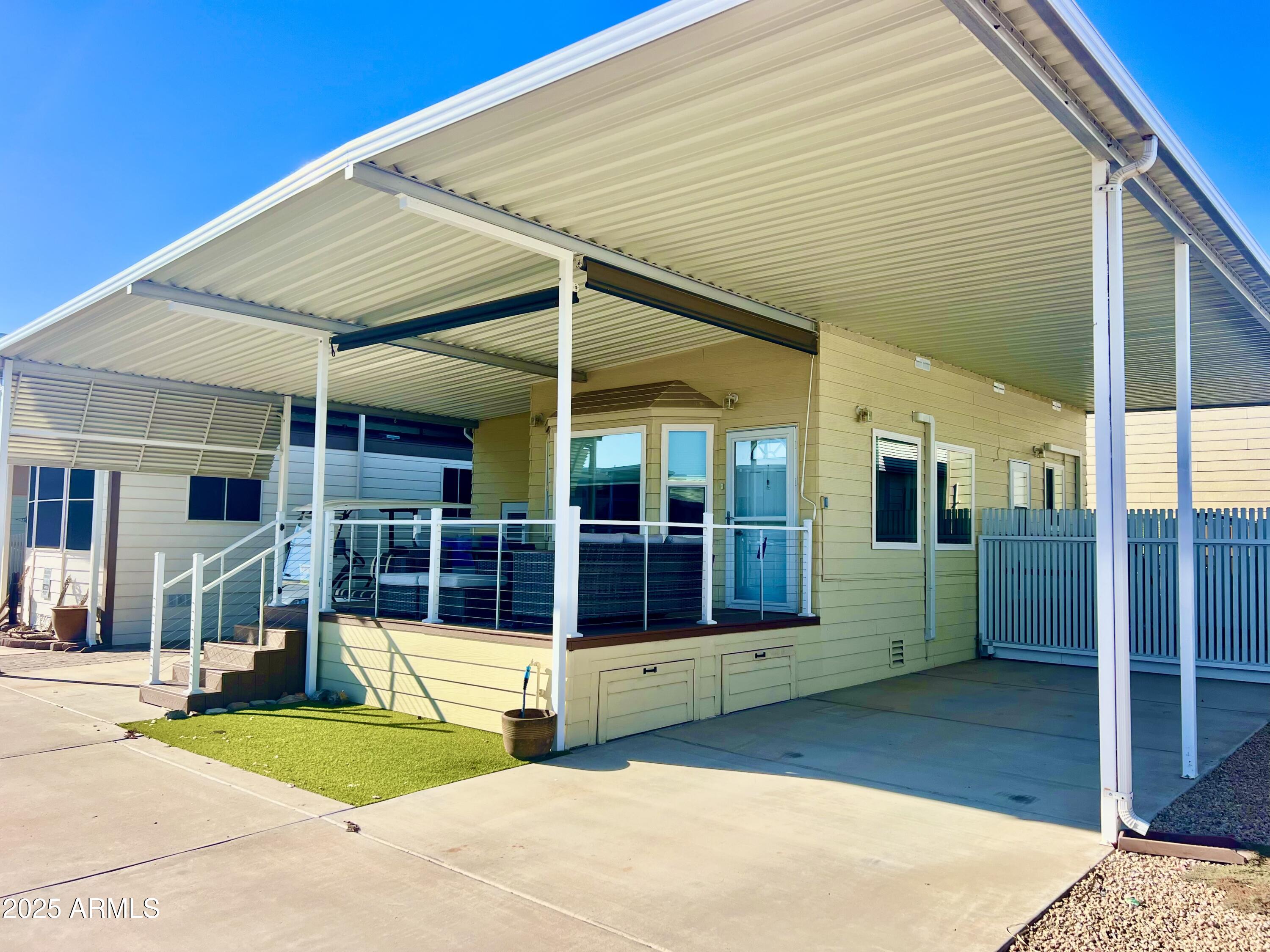 a view of a white house with a swimming pool