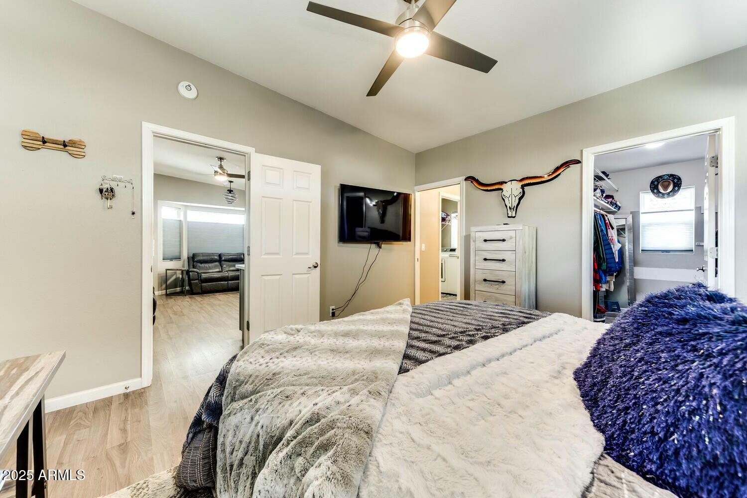 17200 West Bell Road, Unit 903 Surprise, AZ 85374 - Photo 13 of 21 a bedroom with a bed and a flat tv screen on dresser