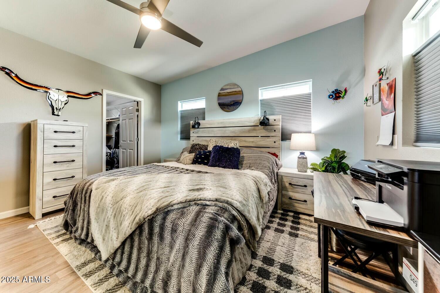 17200 West Bell Road, Unit 903 Surprise, AZ 85374 - Photo 15 of 21 a bedroom with a bed and a chandelier