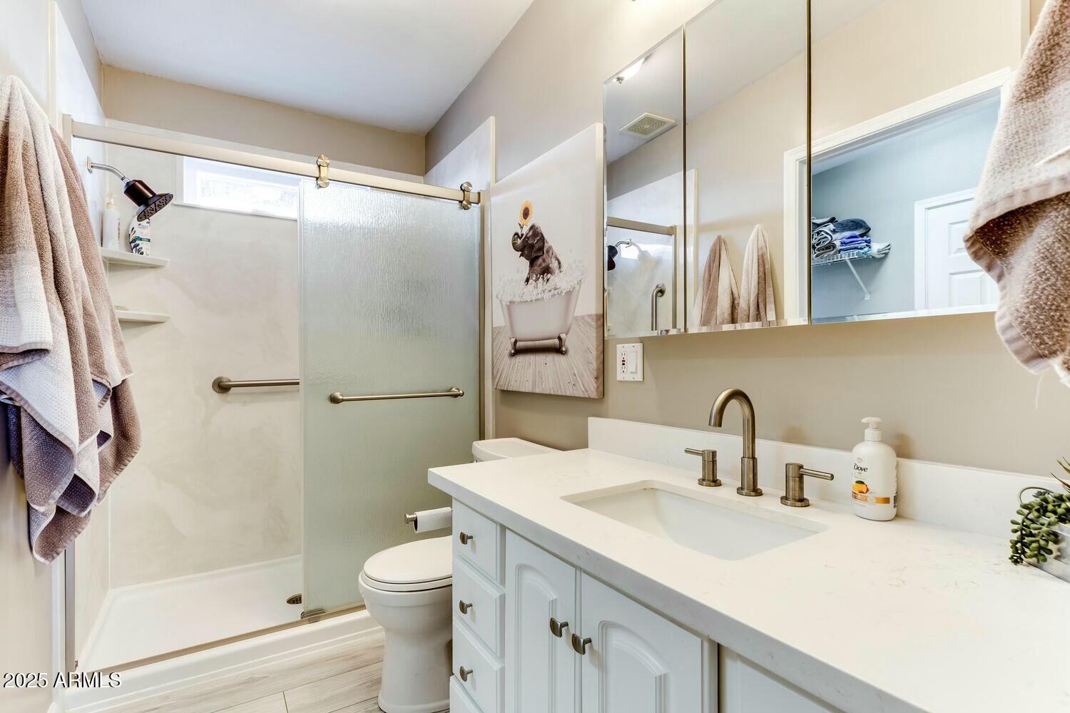 17200 West Bell Road, Unit 903 Surprise, AZ 85374 - Photo 17 of 21 a bathroom with a sink a toilet and shower