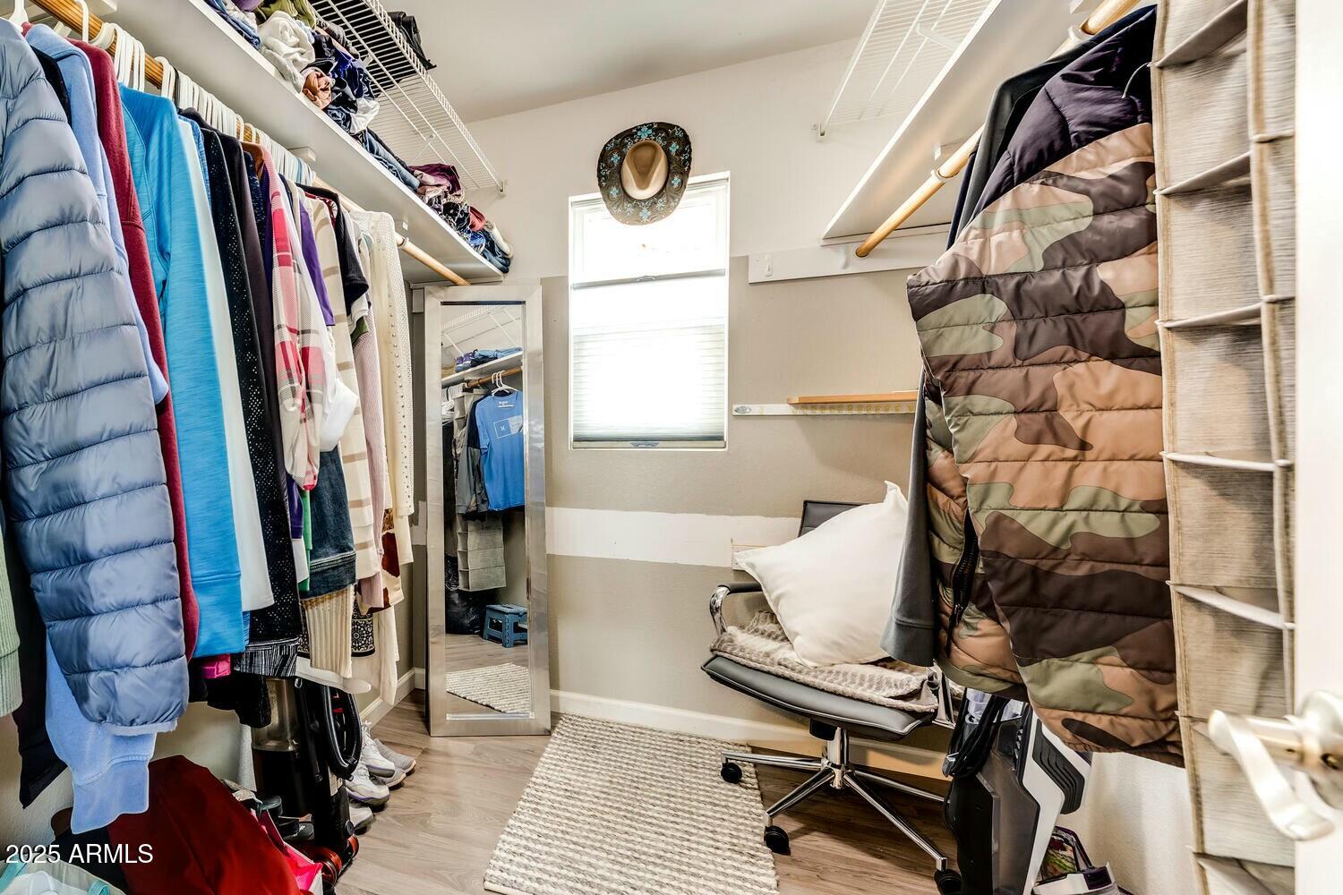 17200 West Bell Road, Unit 903 Surprise, AZ 85374 - Photo 18 of 21 a view of walk in closet with clothes and shoes