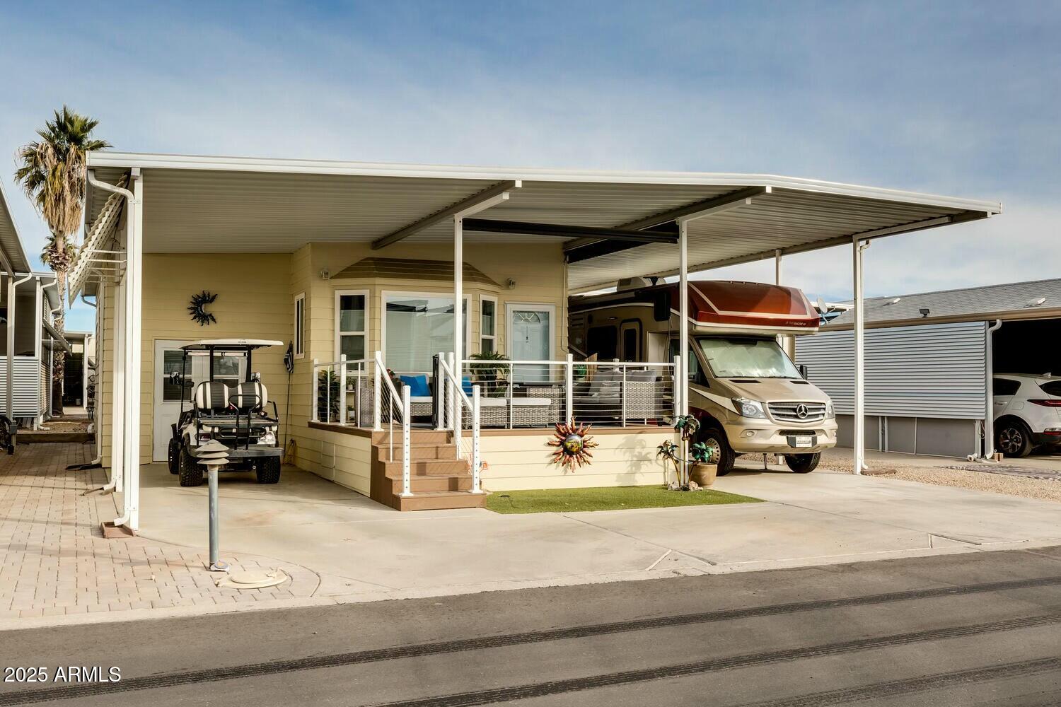 17200 West Bell Road, Unit 903 Surprise, AZ 85374 - Photo 7 of 21 a view of a patio with a table and chairs under an umbrella