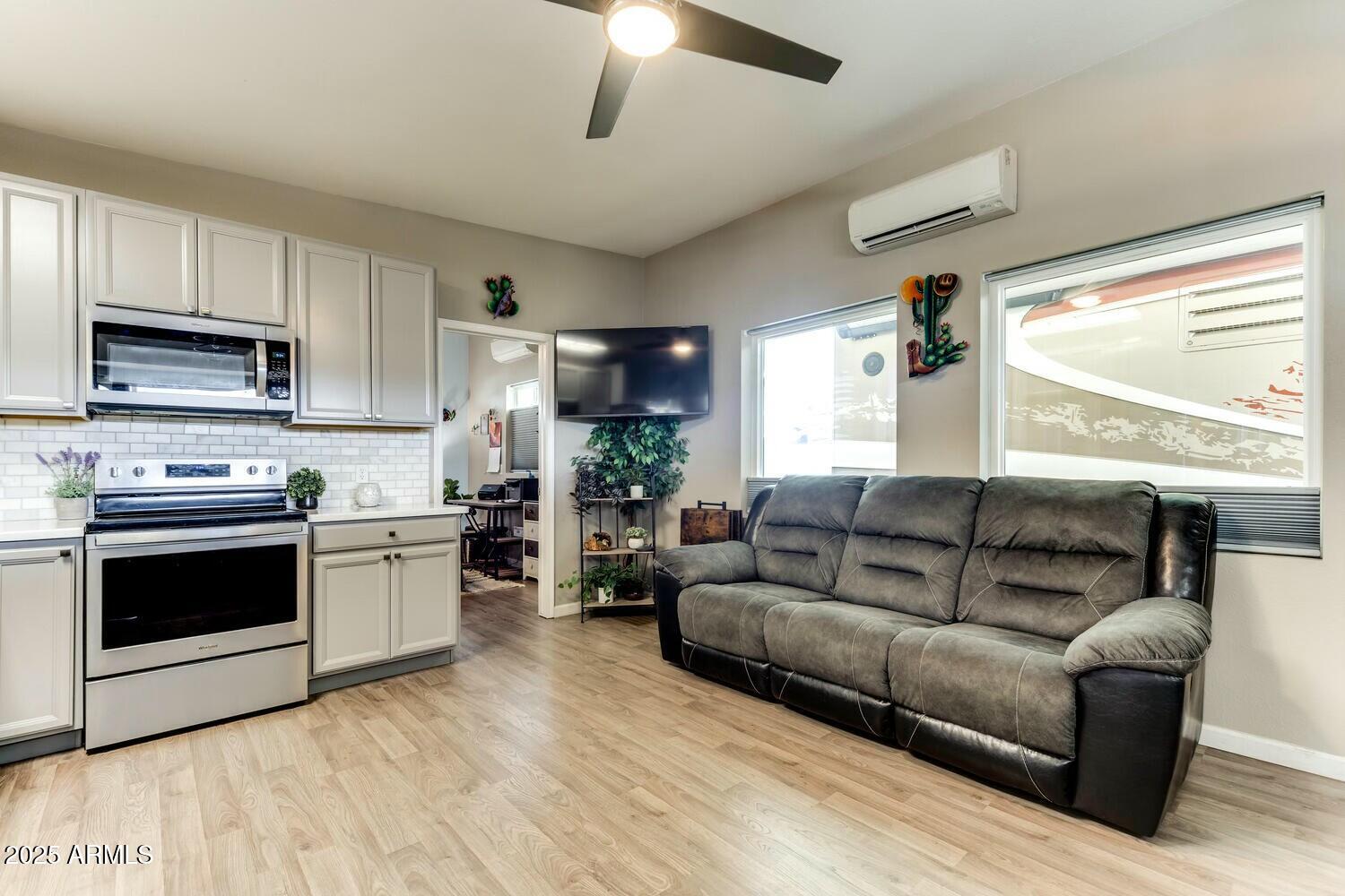 17200 West Bell Road, Unit 903 Surprise, AZ 85374 - Photo 10 of 21 a living room with furniture and a wooden floor