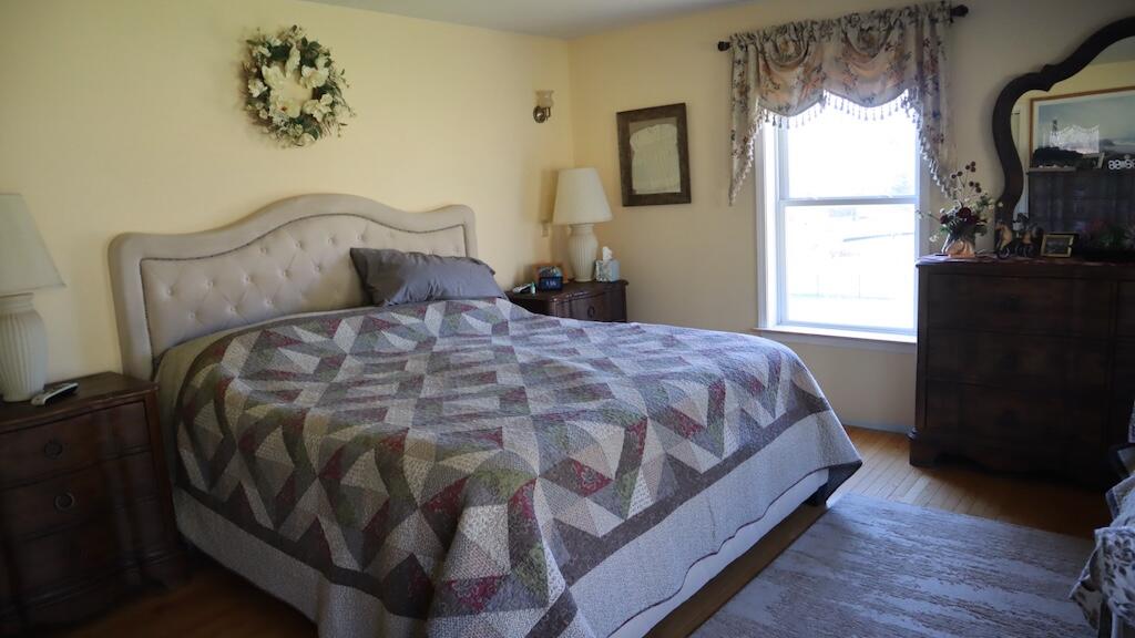 1247 Cannady School Road Southeast Floyd, VA 24091 - Photo 16 of 54 a bedroom with a bed and wooden floor