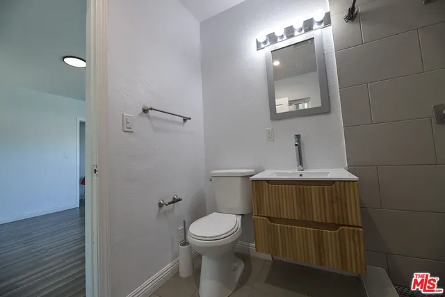 a bathroom with a toilet and a mirror