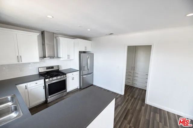 a kitchen with stainless steel appliances granite countertop a stove and a refrigerator