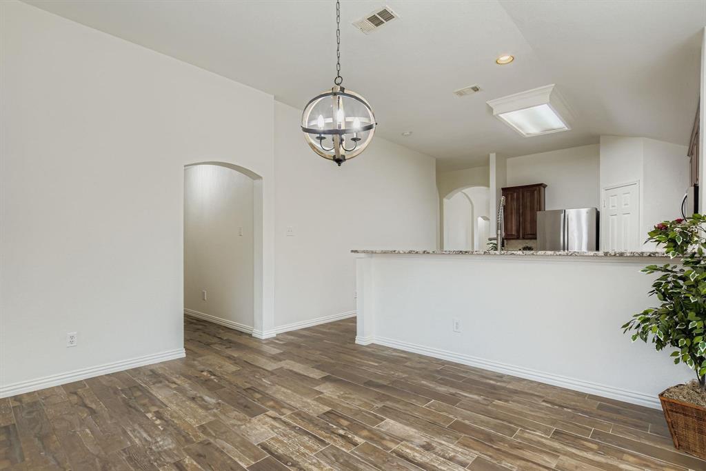 12407 Hawk Creek Drive Frisco, TX 75033 - Photo 13 of 33 a view of a room with wooden floor and potted plant