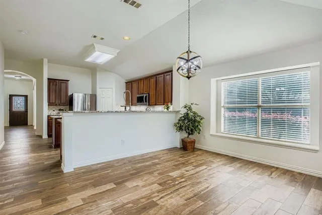 a view of a kitchen with a sink a refrigerator and a window
