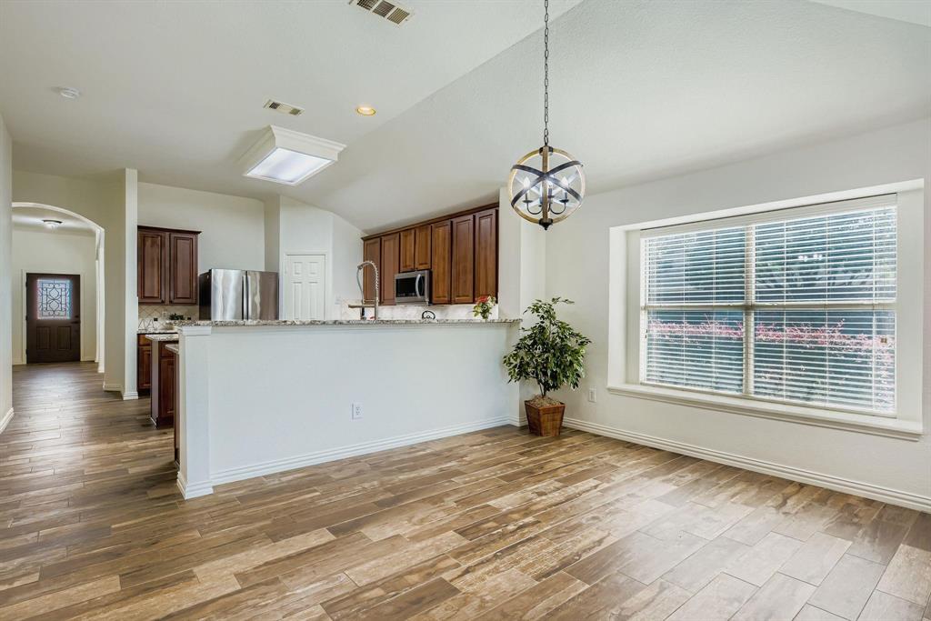 12407 Hawk Creek Drive Frisco, TX 75033 - Photo 14 of 33 a view of a kitchen with a sink a refrigerator and a window