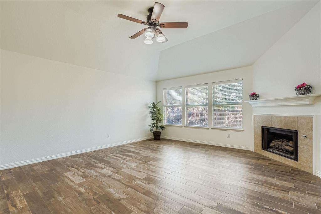 12407 Hawk Creek Drive Frisco, TX 75033 - Photo 16 of 33 a view of empty room with wooden floor and fan