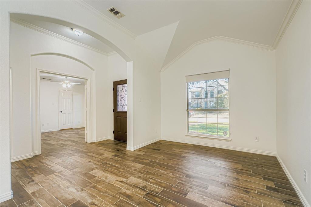12407 Hawk Creek Drive Frisco, TX 75033 - Photo 2 of 33 an empty room with wooden floor and windows
