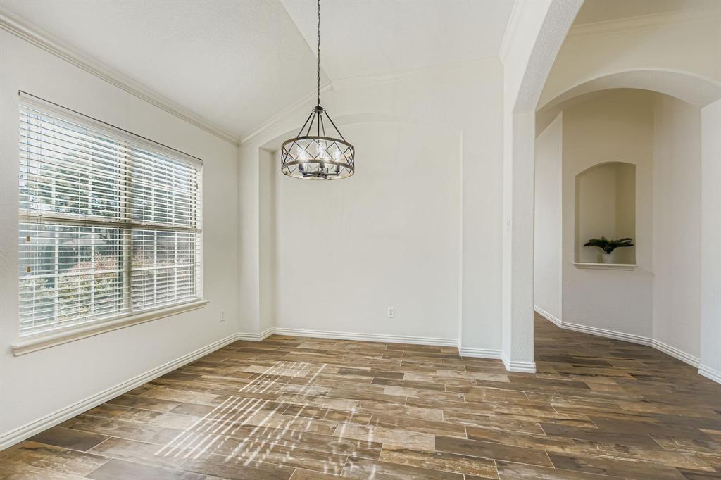 12407 Hawk Creek Drive Frisco, TX 75033 - Photo 5 of 33 a view of an empty room with wooden floor and a window