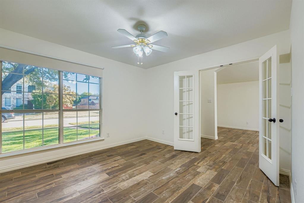 12407 Hawk Creek Drive Frisco, TX 75033 - Photo 6 of 33 wooden floor in an empty room with a window