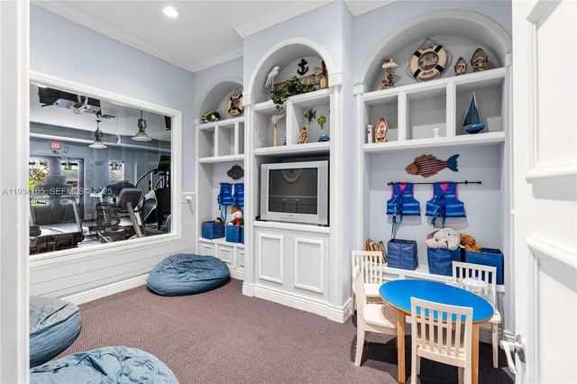 a view of a livingroom with furniture and fan