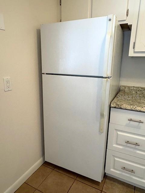 1901 Andover Way, Unit 38 Sun City Center, FL 33573 - Photo 13 of 33 a white refrigerator freezer and a microwave sitting in a kitchen