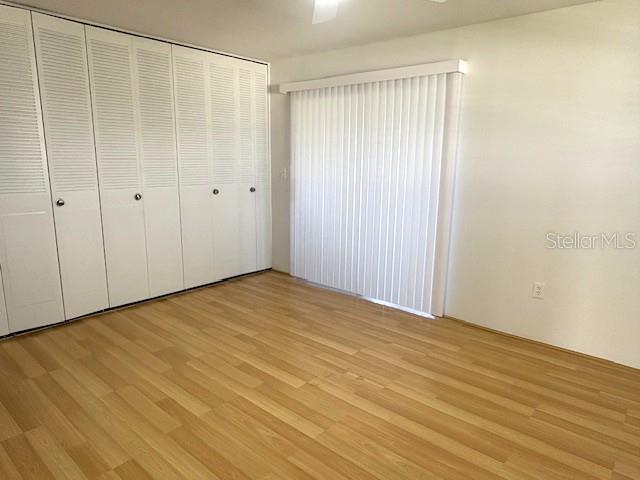 1901 Andover Way, Unit 38 Sun City Center, FL 33573 - Photo 18 of 33 a view of an empty room with wooden floor