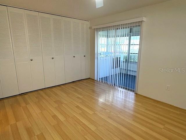 1901 Andover Way, Unit 38 Sun City Center, FL 33573 - Photo 19 of 33 a view of an empty room with wooden floor