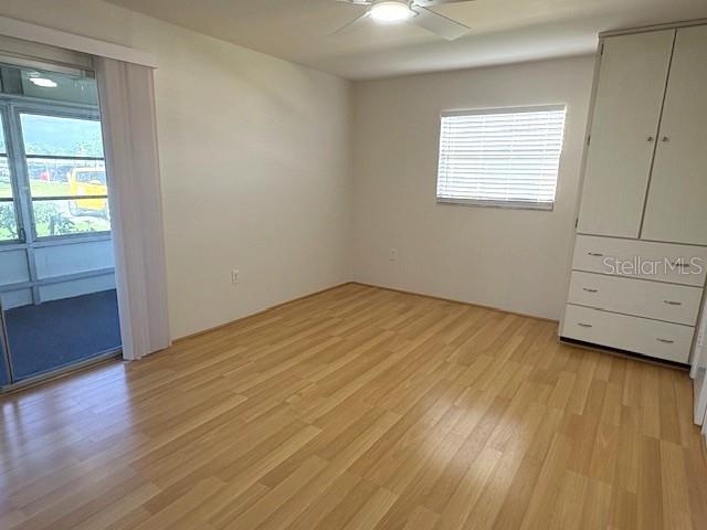 1901 Andover Way, Unit 38 Sun City Center, FL 33573 - Photo 20 of 33 an empty room with wooden floor and windows