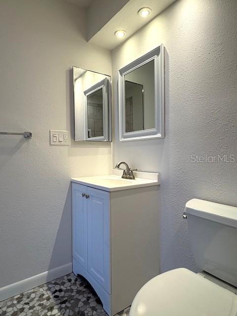 1901 Andover Way, Unit 38 Sun City Center, FL 33573 - Photo 28 of 33 a bathroom with a sink a toilet and mirror