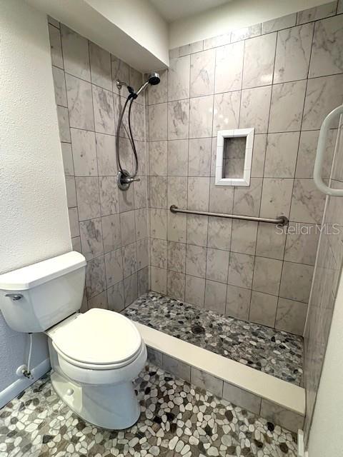 1901 Andover Way, Unit 38 Sun City Center, FL 33573 - Photo 29 of 33 a bathroom with a toilet and shower