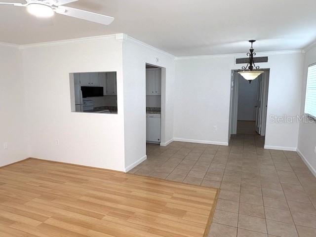 1901 Andover Way, Unit 38 Sun City Center, FL 33573 - Photo 9 of 33 a view of an empty room with wooden floor and a ceiling fan