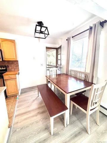 a living room with a table chairs and a flat screen tv