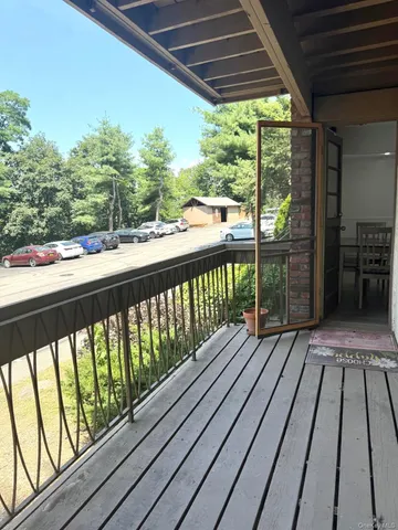 a view of balcony with wooden floor