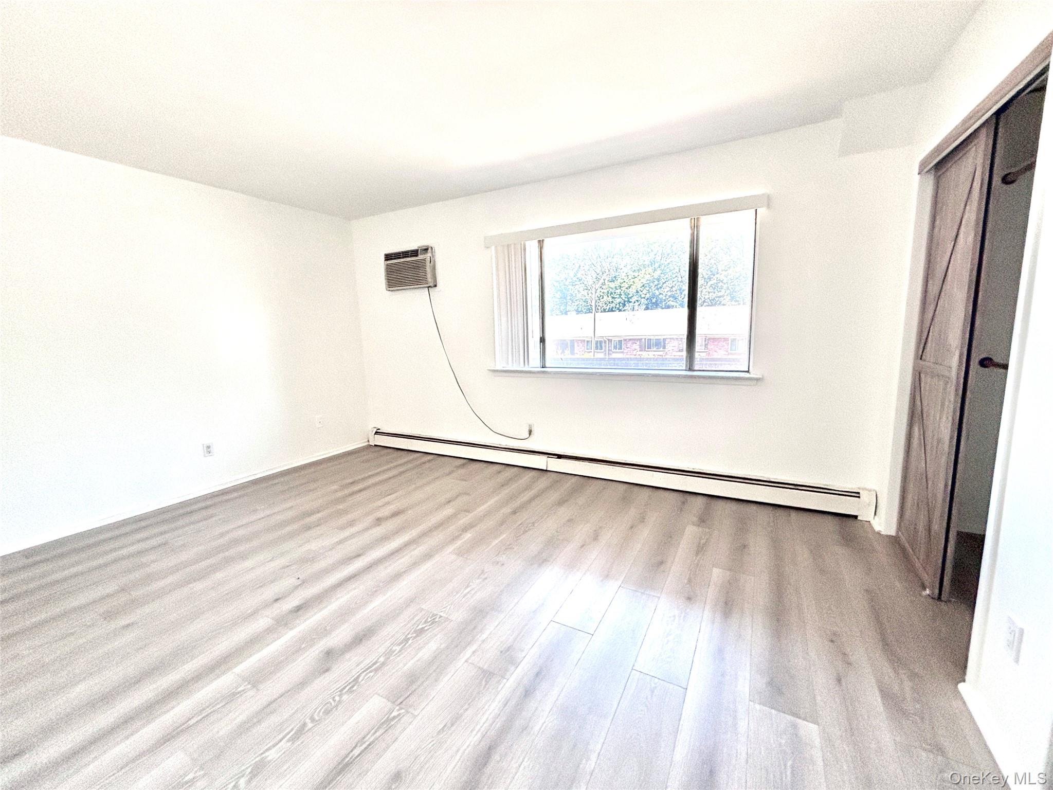 7 North James Street, Unit I Peekskill, NY 10566 - Photo 6 of 8 an empty room with wooden floor and windows