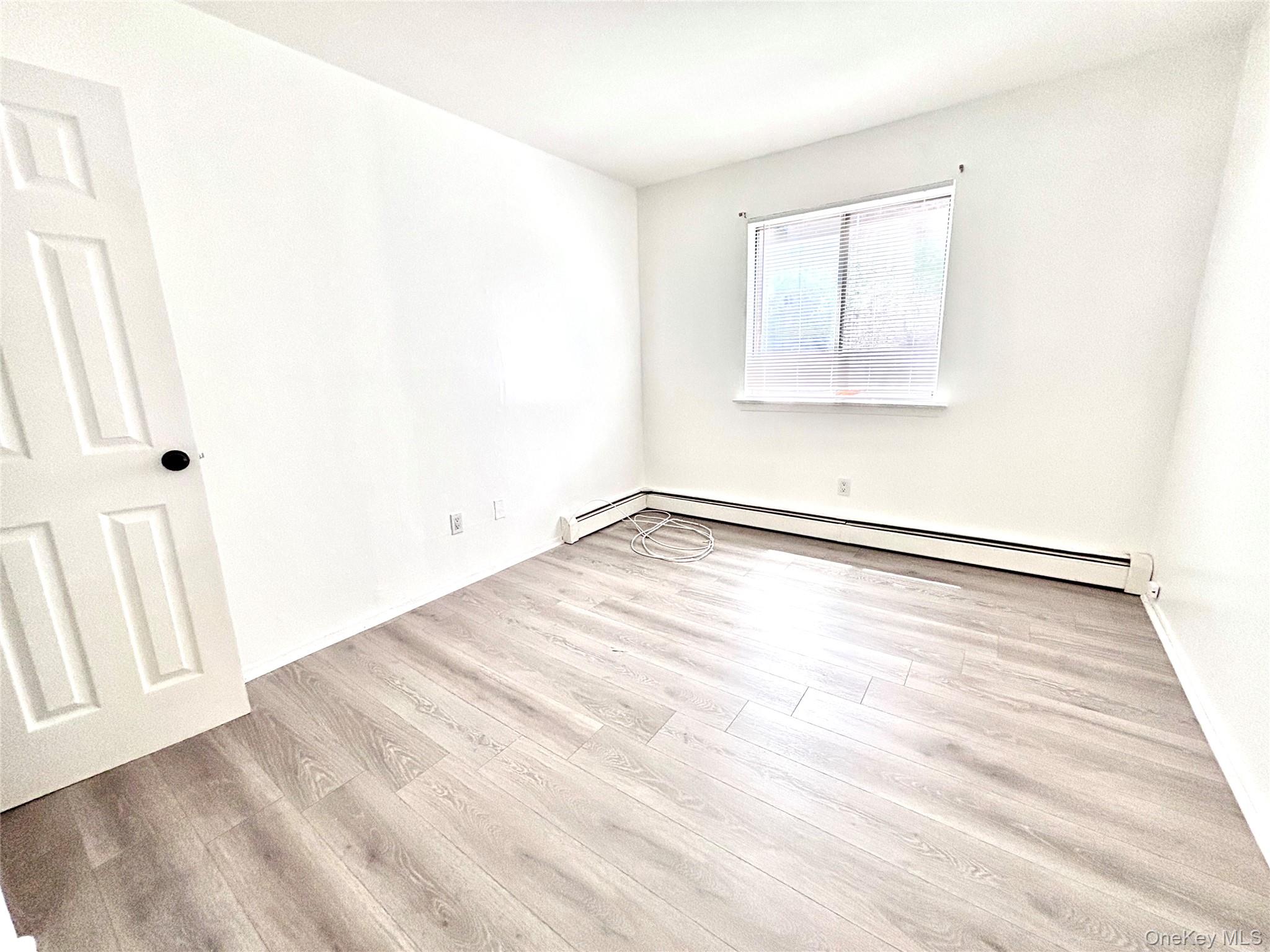 7 North James Street, Unit I Peekskill, NY 10566 - Photo 7 of 8 an empty room with wooden floor and windows