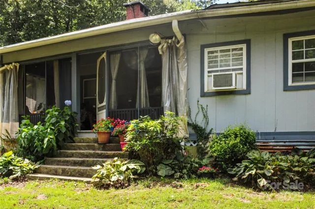 a view of a house with potted plants