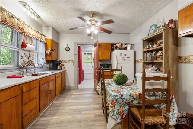 a kitchen with stainless steel appliances kitchen island granite countertop a refrigerator and a stove