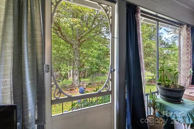 a view of a room that has a bed and a potted plant