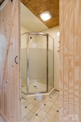 a bathroom with a glass shower door