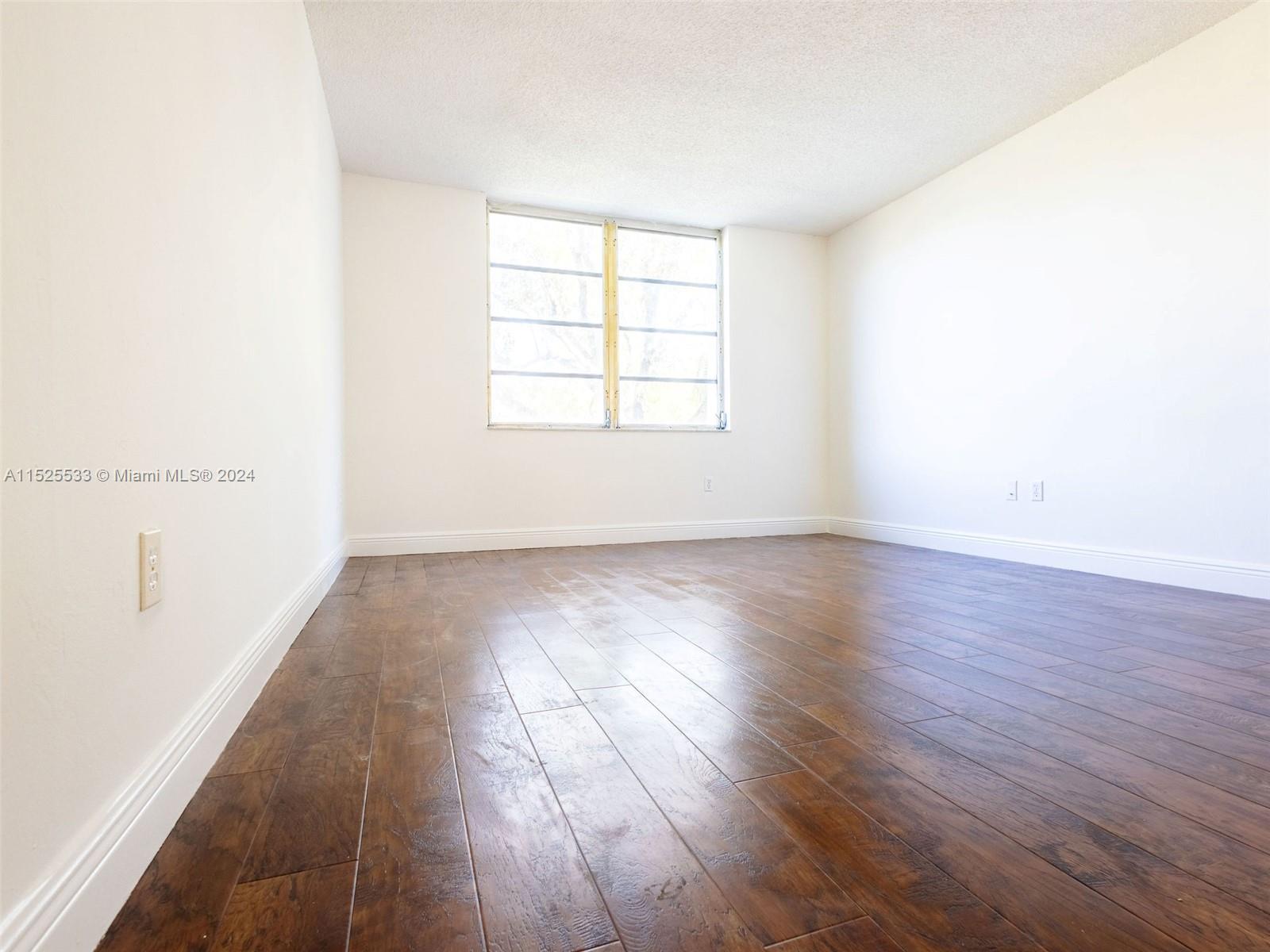 3285 Foxcroft Road, Unit E206 Miramar, FL 33025 - Photo 15 of 35 an empty room with wooden floor and windows