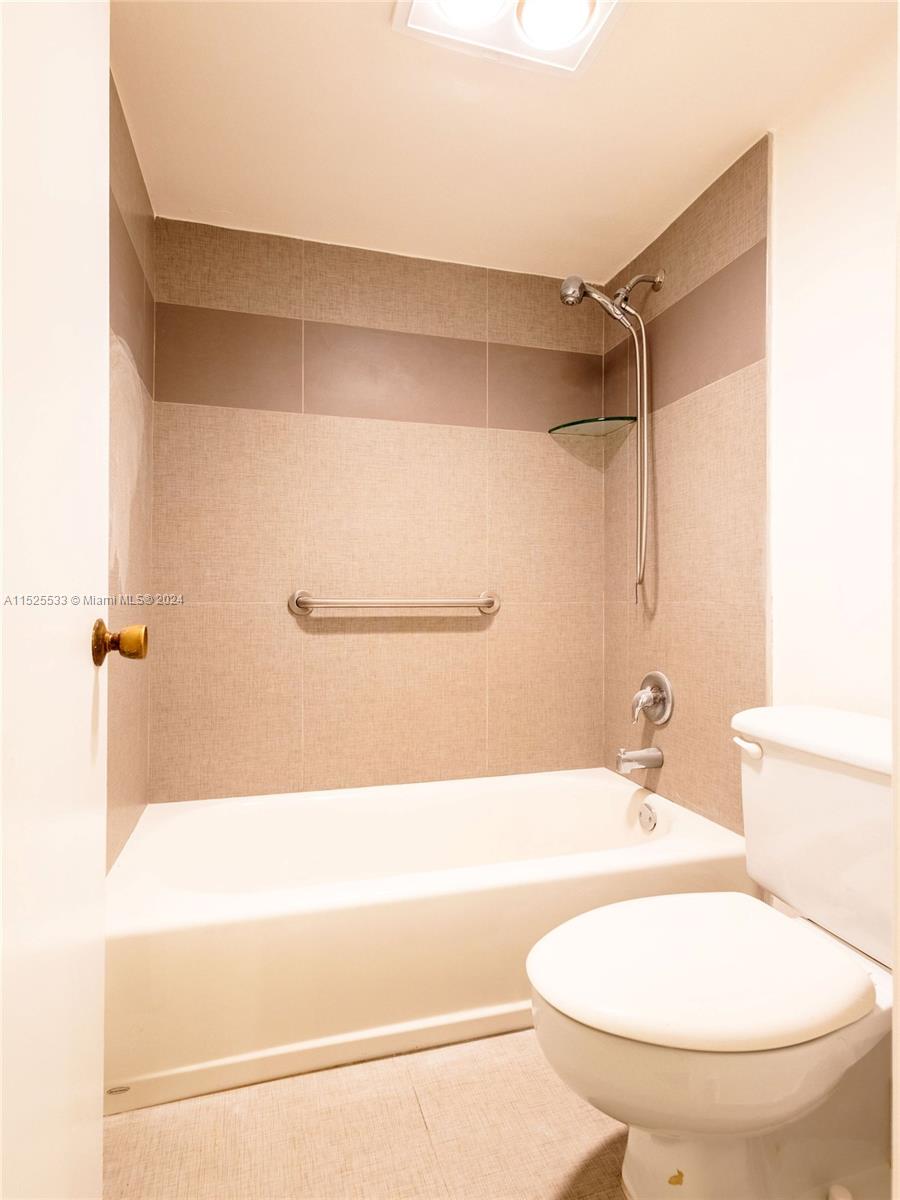 3285 Foxcroft Road, Unit E206 Miramar, FL 33025 - Photo 18 of 35 a bathroom with a shower and a toilet