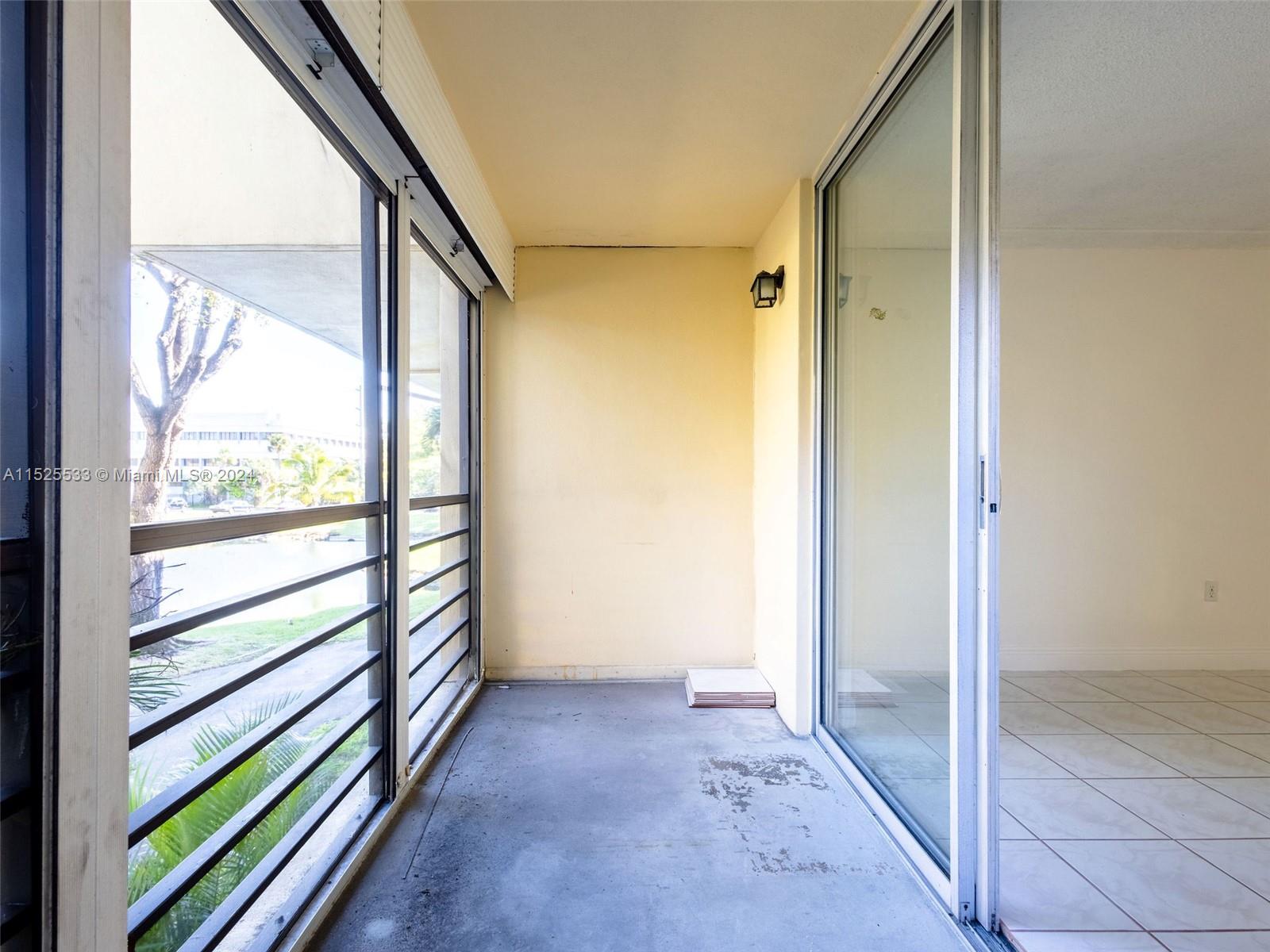 3285 Foxcroft Road, Unit E206 Miramar, FL 33025 - Photo 21 of 35 an empty room with wooden floor and windows