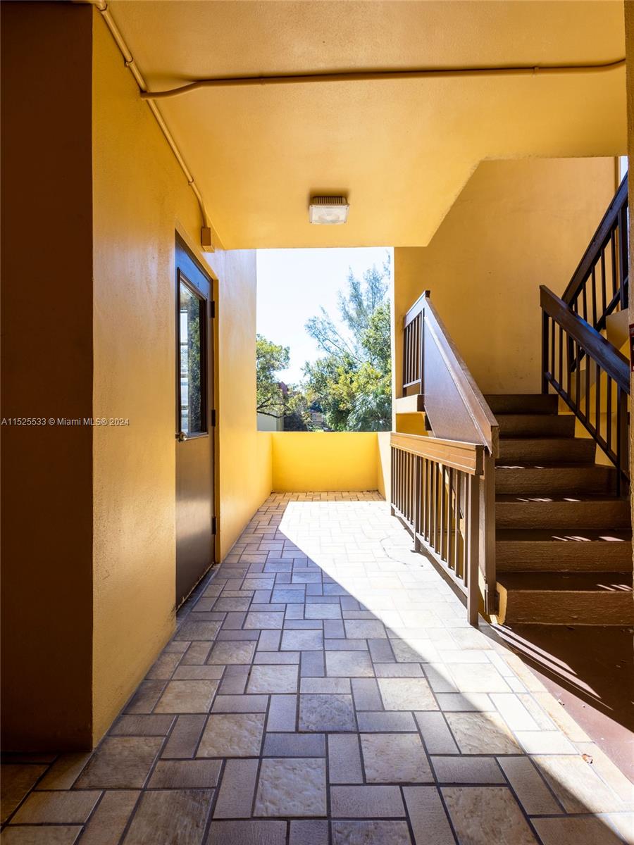3285 Foxcroft Road, Unit E206 Miramar, FL 33025 - Photo 24 of 35 a view of a balcony with wooden floor