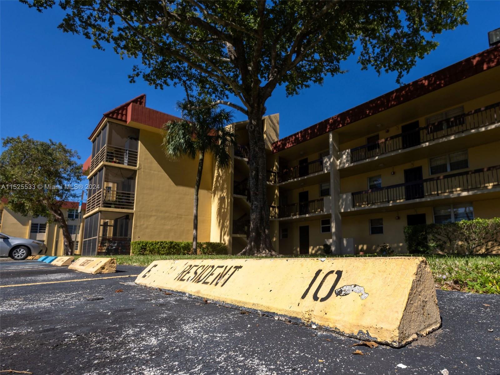 3285 Foxcroft Road, Unit E206 Miramar, FL 33025 - Photo 34 of 35 a view of a street with a building in the background
