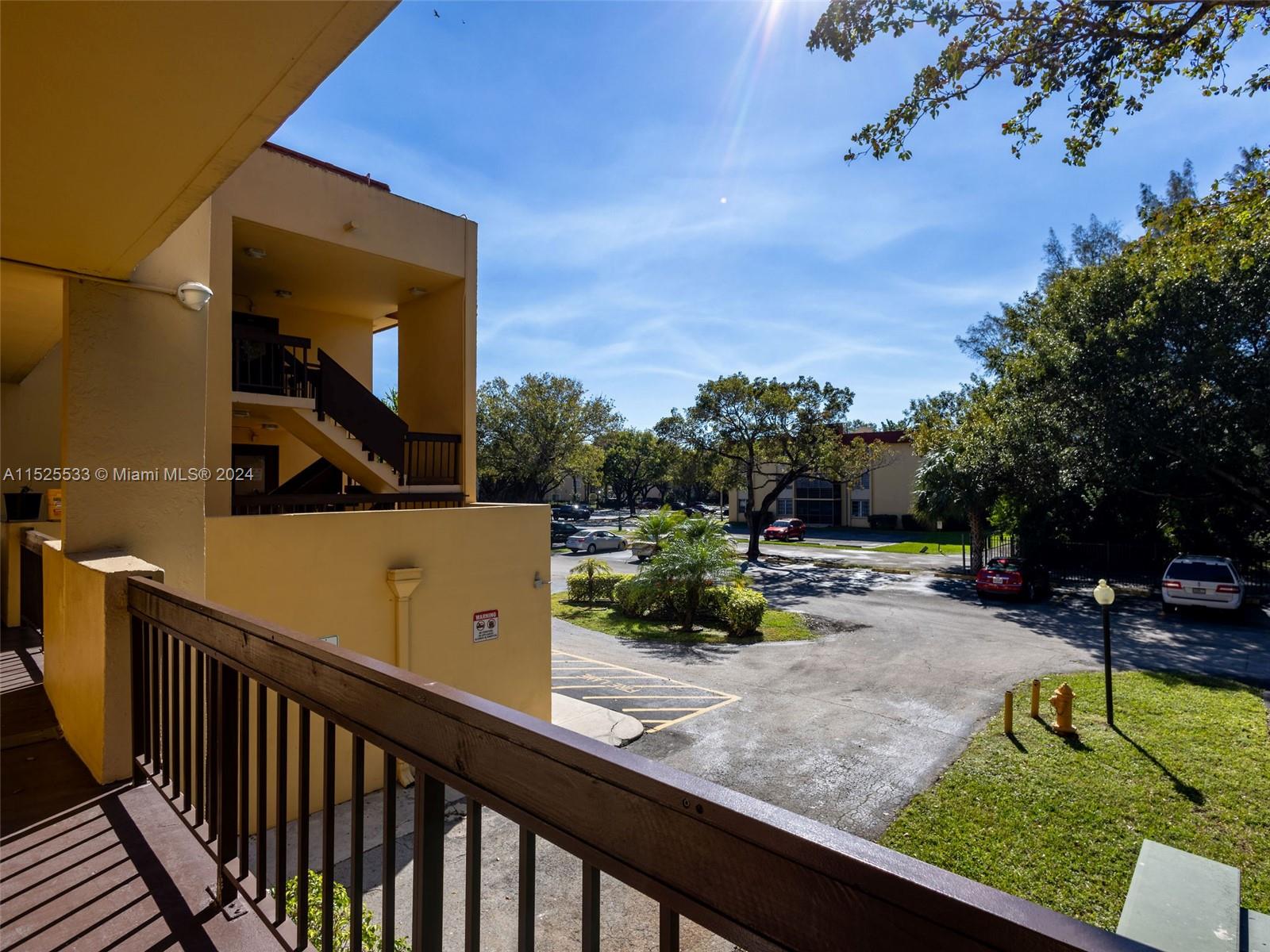 3285 Foxcroft Road, Unit E206 Miramar, FL 33025 - Photo 4 of 35 a view of a swimming pool with a patio and a garden