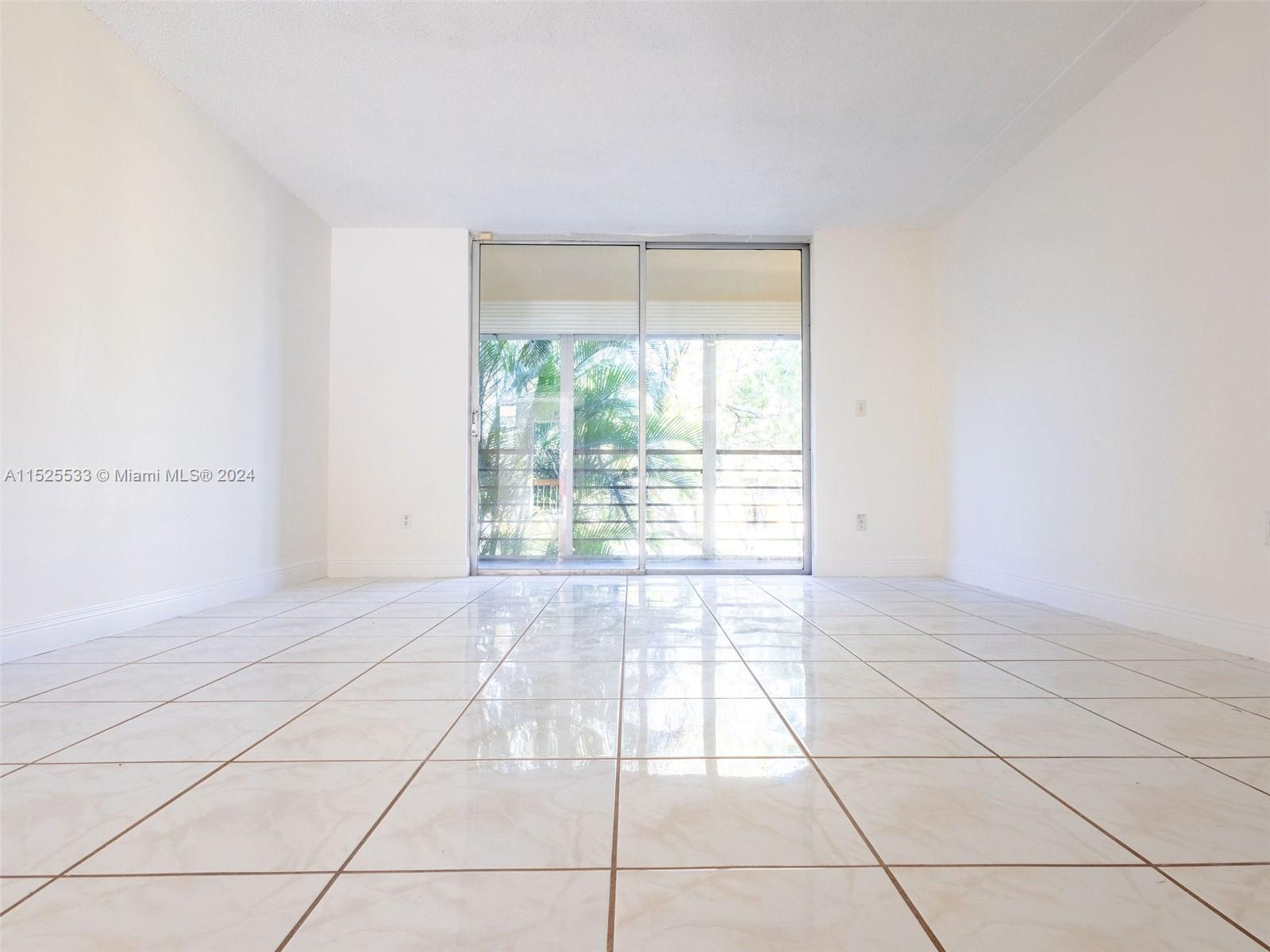 3285 Foxcroft Road, Unit E206 Miramar, FL 33025 - Photo 6 of 35 a view of an empty room with a window