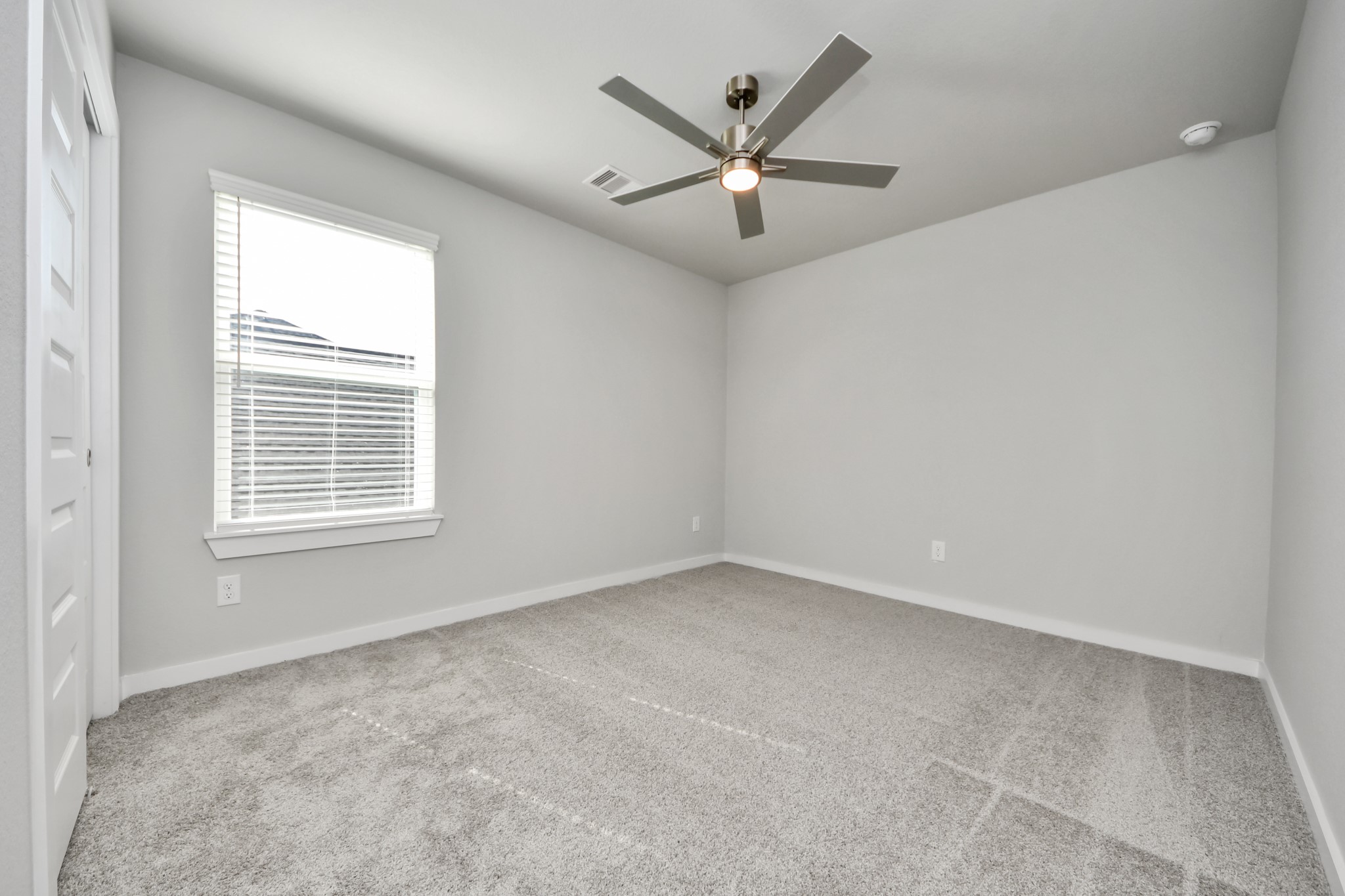 2934 Burris Park Drive Spring, TX 77373 - Photo 28 of 35 Secondary bedroom features plush carpeting, large windows that let in plenty of natural light, bright paint, and spacious closets. Sample photo of completed home with similar floor plan. Actual colors and selections may vary.