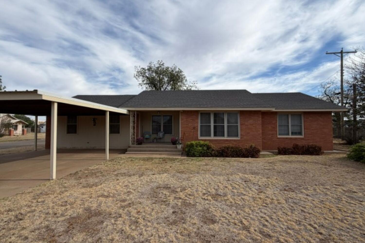 a front view of a house with a garden and yard