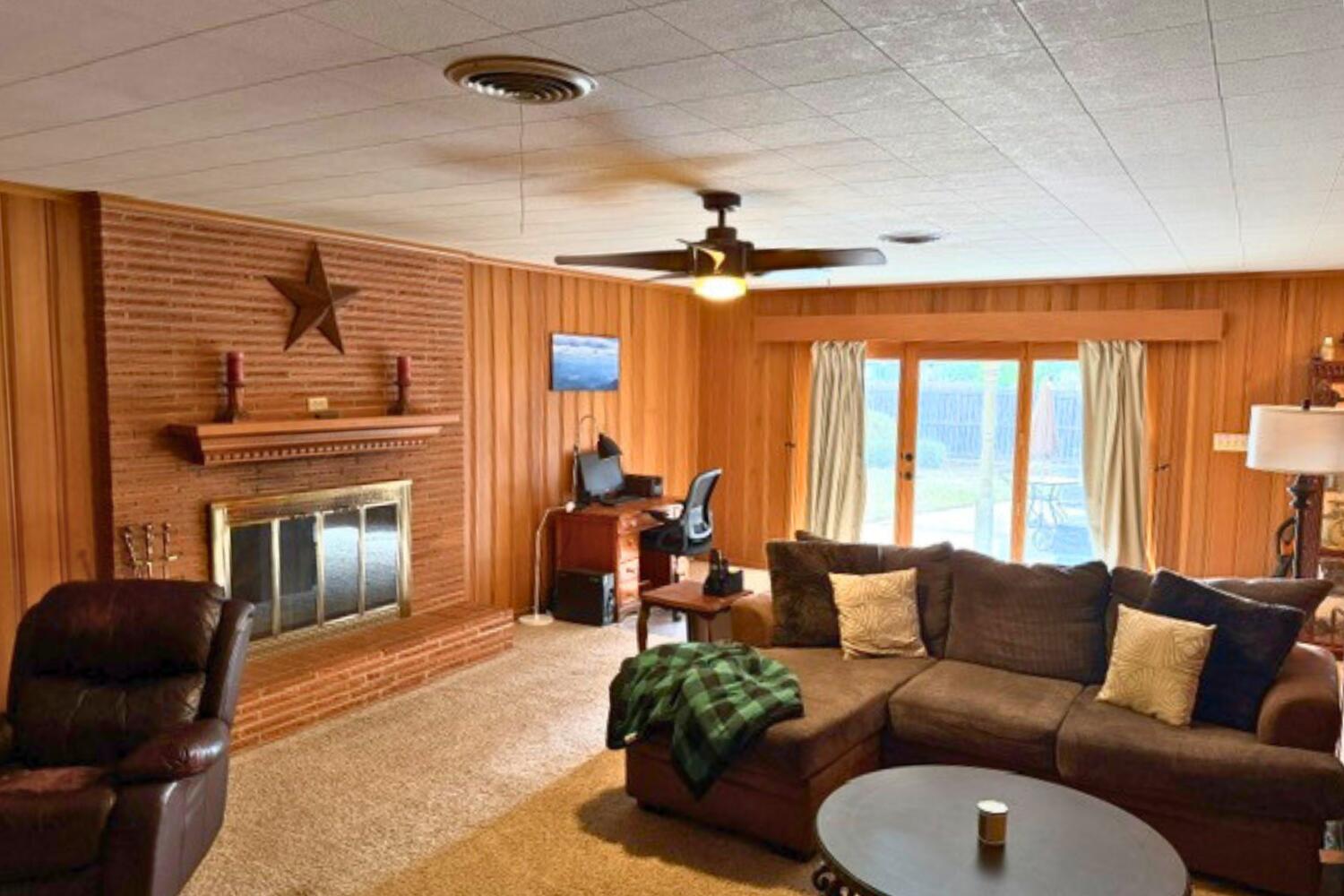 320 West Spruce Street Lockney, TX 79241 - Photo 11 of 24 a living room with furniture and a fireplace