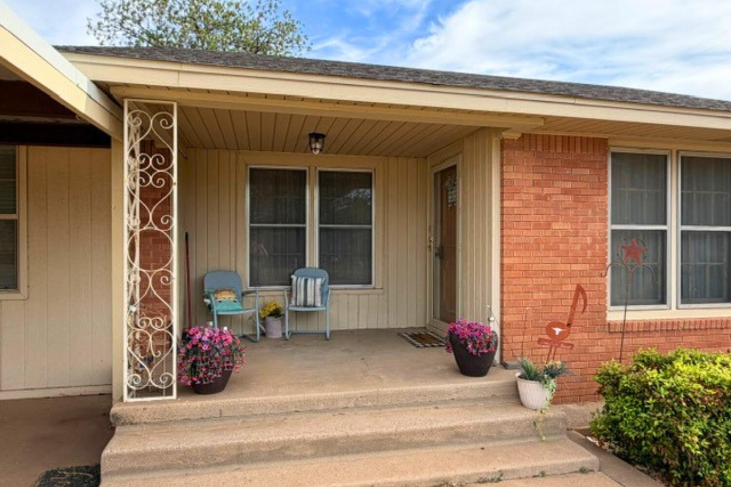 320 West Spruce Street Lockney, TX 79241 - Photo 2 of 24 a view of a porch with a bench and potted plants