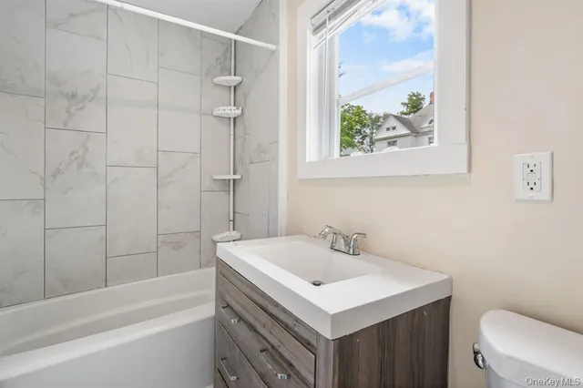a bathroom with a sink a toilet and a bathtub