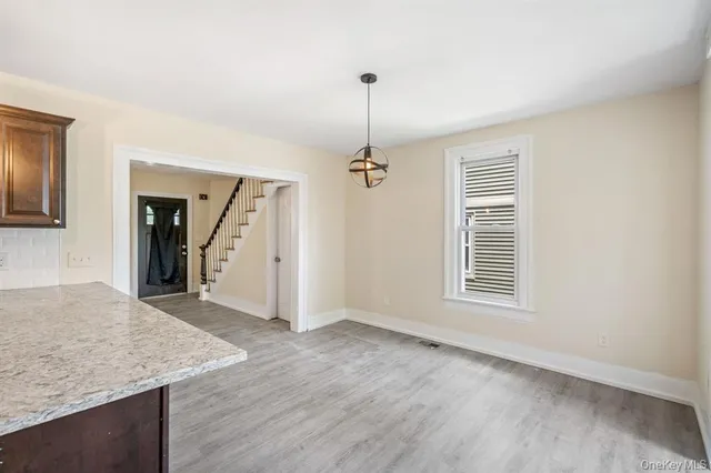 an empty room with windows and entrance